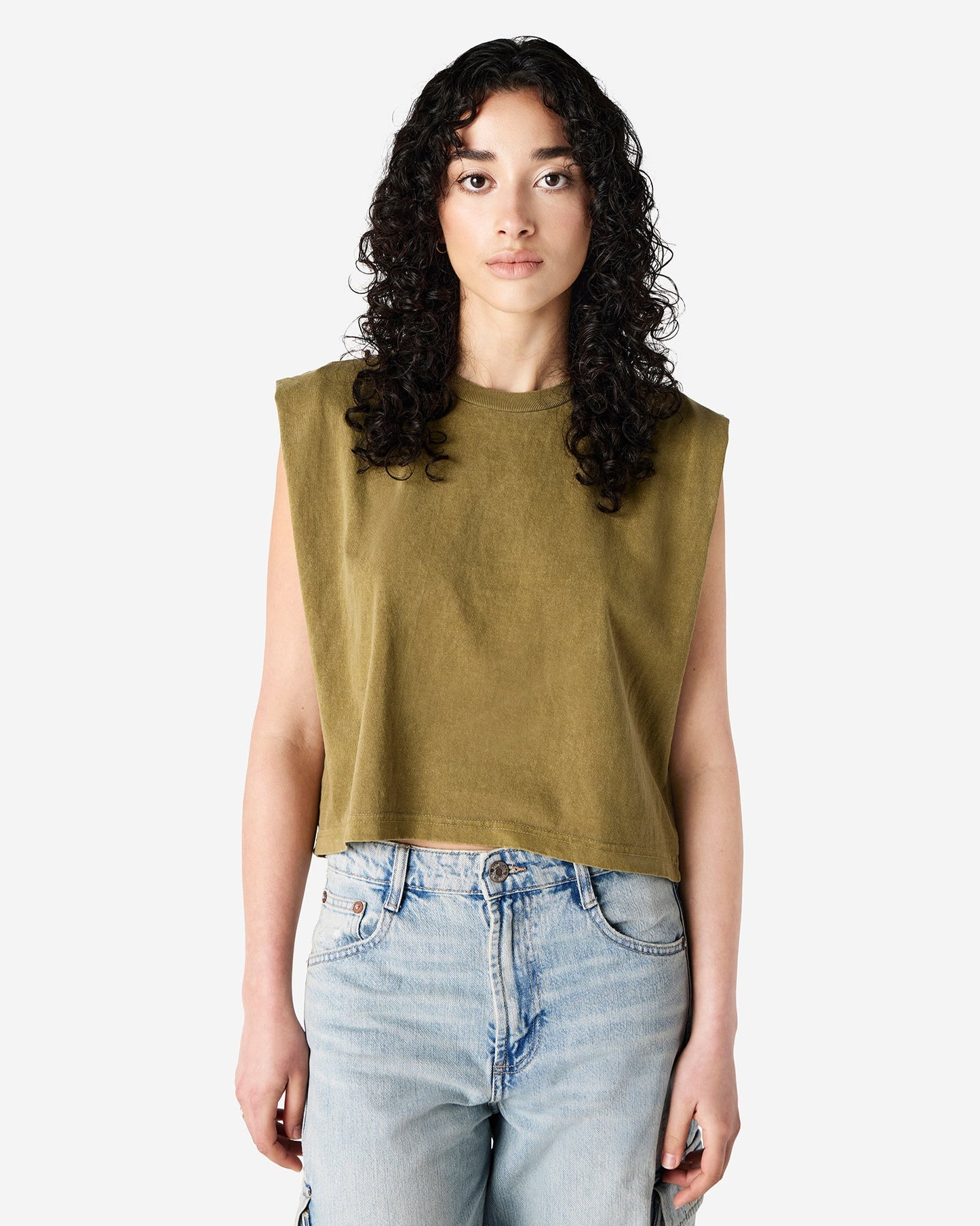 Model wearing American Apparel® 307GD Women’s Muscle T-Shirt in Faded Army, sleeveless cotton tee with crew neck and relaxed cropped fit-faded army